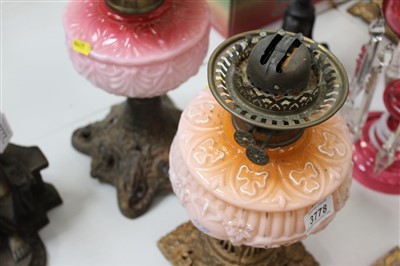 Lot 3778 - Two late Victorian oil lamps with floral moulded opaque pink glass reservoirs