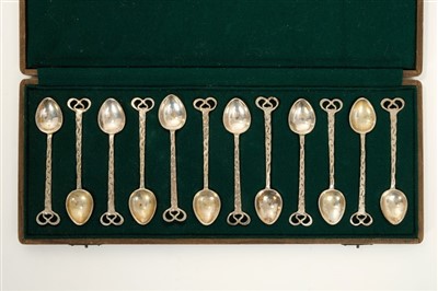 Lot 318 - Set of 12 Arts & Crafts silver coffee spoons in fitted case