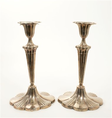 Lot 227 - Pair of Edwardian silver candle sticks of shaped oval form.