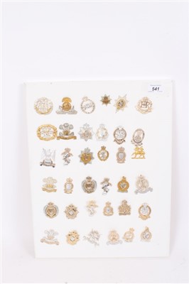 Lot 541 - Group of thirty six British Military staybrite cap badges, to include Royal Engineers, Lancashire Fusiliers and Royal Anglian Regiment, mounted on board