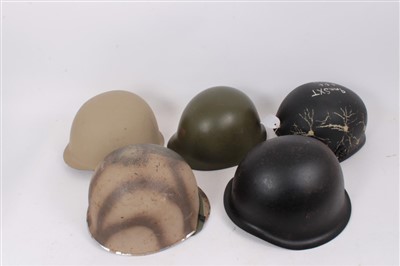 Lot 589 - Group of various military helmets to include American M1 style helmet, Danish M39 helmet, Chinese steel helmet, Egyptian steel helmet and an American combat helmet (5)