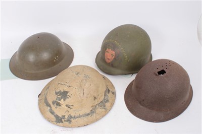 Lot 593 - Group of various military helmets to include American M1917 steel helmet, French M26 steel helmet, Dutch steel helmet, and an American M1 helmet (4)