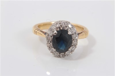 Lot 3268 - Gold (18ct) sapphire and diamond cluster ring