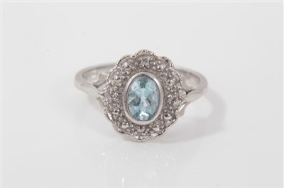 Lot 3292 - White gold (18ct) aquamarine and diamond cluster ring