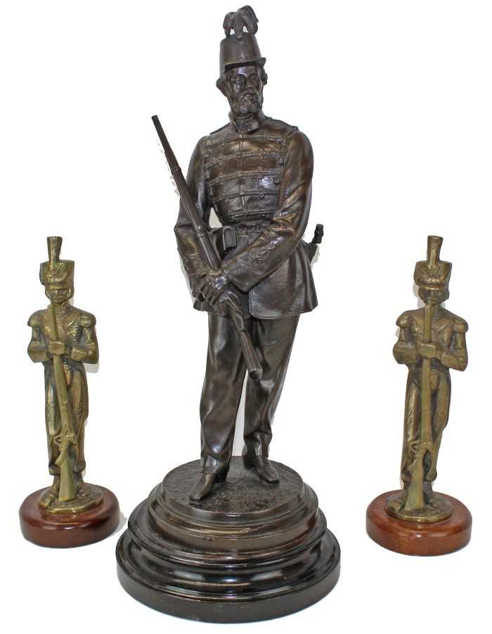 Lot 3617 - Victorian spelter figure of a soldier in the Rifle Volunteers, mounted on a turned wooden plinth, together with a pair of brass military figures. (3)