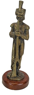 Lot 3617 - Victorian spelter figure of a soldier in the Rifle Volunteers, mounted on a turned wooden plinth, together with a pair of brass military figures. (3)