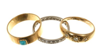 Lot 497 - Three rings- diamond eternity ring, diamond three stone gypsy ring and a gold band with a turquoise cabachon