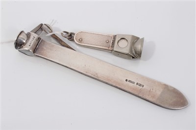 Lot 3656 - Edwardian Asprey & Co silver cigar cutter (London 1910), 14cm long, together with another with engine turned decoration (2)