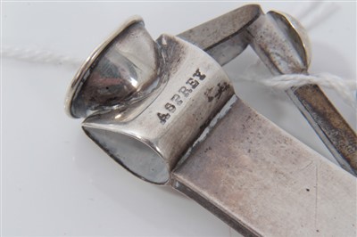 Lot 3656 - Edwardian Asprey & Co silver cigar cutter (London 1910), 14cm long, together with another with engine turned decoration (2)