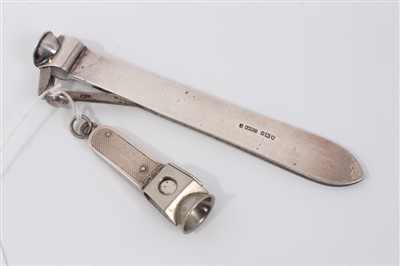 Lot 3656 - Edwardian Asprey & Co silver cigar cutter (London 1910), 14cm long, together with another with engine turned decoration (2)