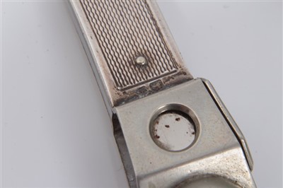 Lot 3656 - Edwardian Asprey & Co silver cigar cutter (London 1910), 14cm long, together with another with engine turned decoration (2)