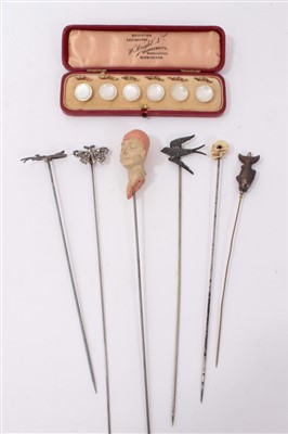 Lot 3374 - Six novelty hatpins including ivory skull and female head and cased set of mother o' pearl dress buttons
