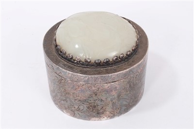 Lot 1283 - Chinese white metal box of cylindrical form, the cover mounted with oval convex pale green plaque carved in low relief with birds in a landscape, 10cm wide