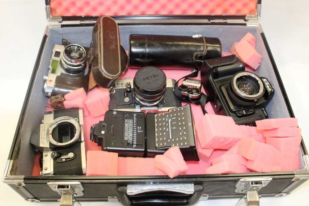 Lot 3692 - Four vintage 35mm cameras comprising two Petri SLRs, a Petri range finder and a Nikon F601 body, together with a Petri 200mm lens and meter and a flash gun