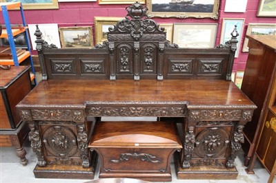 Lot 1339 - A highly ornate Victorian carved oak twin pedestal sideboard with raised back