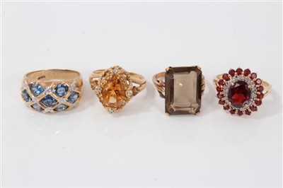 Lot 3388 - Four 9ct gold gem set dress rings to include smokey quartz