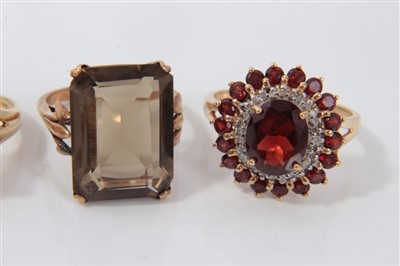 Lot 3388 - Four 9ct gold gem set dress rings to include smokey quartz