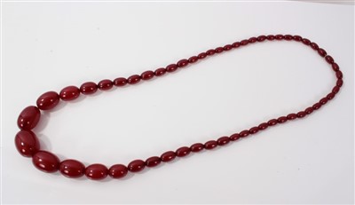 Lot 3395 - Simulated cherry amber graduated bead necklace