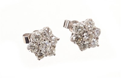 Lot 437 - Pair of brilliant cut diamond star shaped cluster stud earrings. Estimated total diamond weight approximately 1.79cts