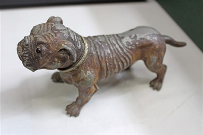 Lot 3726 - An amusing vintage novelty cold painted spelter lighter in the form of a bulldog, the lighter concealed by the hinged dog’s head operated by the tail. 20cm