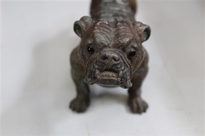 Lot 3726 - An amusing vintage novelty cold painted spelter lighter in the form of a bulldog, the lighter concealed by the hinged dog’s head operated by the tail. 20cm