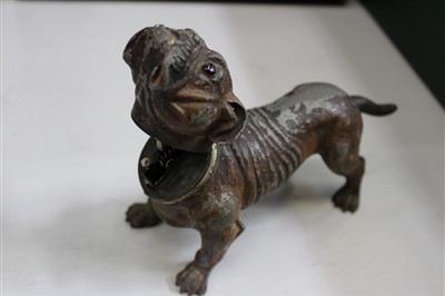 Lot 3726 - An amusing vintage novelty cold painted spelter lighter in the form of a bulldog, the lighter concealed by the hinged dog’s head operated by the tail. 20cm