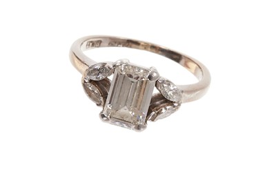 Lot 408 - Diamond ring with a baguette cut diamond flanked by marquise cut diamonds to the open shoulders, in platinum claw setting on 18ct white gold shank. Finger size I