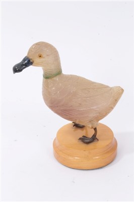 Lot 3710 - Unusual carved hard stone figure of a duck with white metal webbed feet on wooden base 12cm