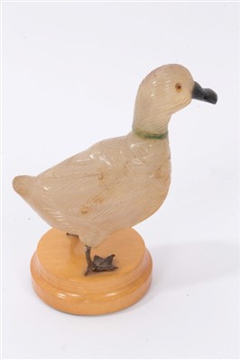 Lot 3710 - Unusual carved hard stone figure of a duck with white metal webbed feet on wooden base 12cm