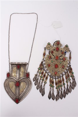 Lot 3410 - Two antique Turkmen white metal pendants with gilt decoration and gemstone cabochons