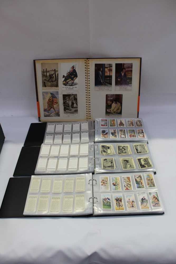 Lot 2519 - Cigarette card selection in albums mostly Players and Wills, large and small cards. Plus an album of Military interest postcards including Bairnsfather, WW1 silks etc.