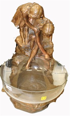 Lot 3808 - Interesting water feature, comprising a large circular glass bowl mounted in a bronzed plaster base, in the form of two young women on a rock looking down into the bowl