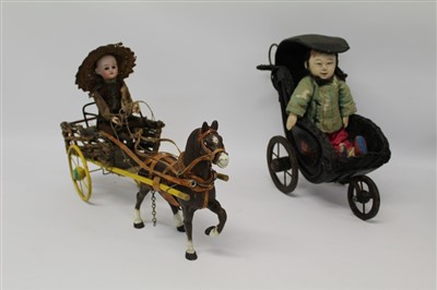 Lot 2778 - Late 19th century metal horse and carriage, wooden driver with bisque head, together with a Chinese composite doll in original clothing seated in a black wicker carriage