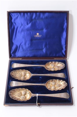 Lot 216 - Set of four Georgian silver berry spoons in fitted case (blue velvet)