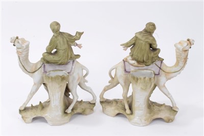 Lot 97 - A pair of Continental porcelain groups of camels and attendants