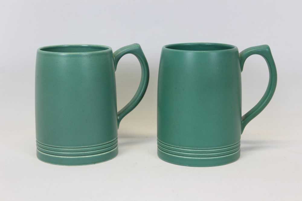 Lot 72 - Pair of green Keith Murray Wedgewood tankards, 12cm high