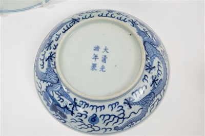 Lot 14 - Set five 19th century Chinese blue and white saucer dishes with painted dragon chasing pearl decoration to front and back and six character Guangxu marks and probably of the period 16.5cm