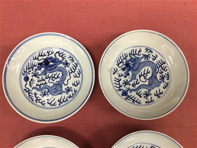 Lot 14 - Set five 19th century Chinese blue and white saucer dishes with painted dragon chasing pearl decoration to front and back and six character Guangxu marks and probably of the period 16.5cm