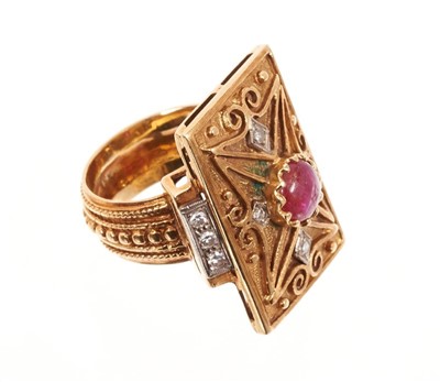 Lot 488 - Eastern gold dress ring, the rectangular plaque with a central cabochon ruby and single cut diamonds, on beaded shank. Finger size approximately K