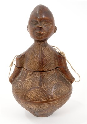 Lot 855 - Unusual African tribal figural vessel, the bulbous body with striated ornament, dividing at the waist, the head with ladle to the rear