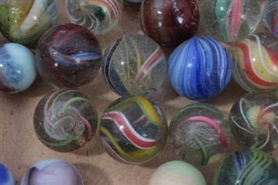 Lot 16 - Good collection of Victorian glass and stone marbles, including approximately fifteen polychrome helix and swirl examples, the largest 17mm diameter