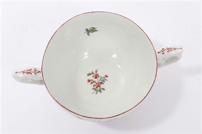 Lot 41 - 18th century Chelsea Derby trembleuse two handled cup and saucer with polychrome painted floral sprays
