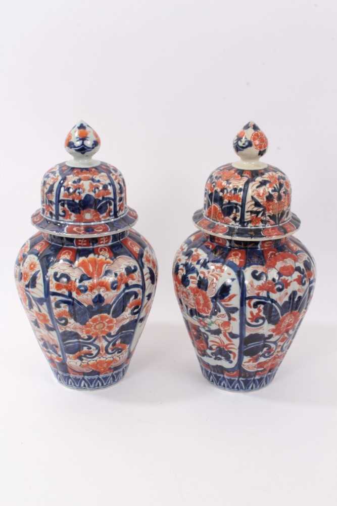 Lot 101 - Pair of Japanese Imari ovoid vases and domed covers