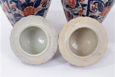 Lot 101 - Pair of Japanese Imari ovoid vases and domed covers