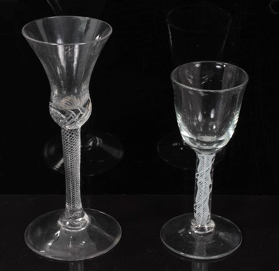 Lot 81 - 18th century wine glass with trumpet bowl and air twist stem on splayed foot 17cm and another with double opaque twist stem 14cm (2)