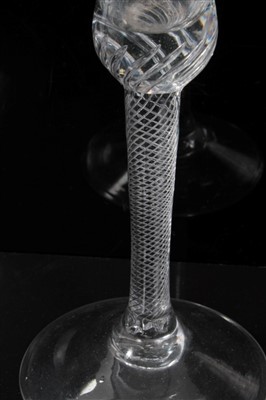 Lot 81 - 18th century wine glass with trumpet bowl and air twist stem on splayed foot 17cm and another with double opaque twist stem 14cm (2)