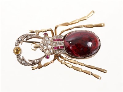 Lot 522 - Victorian-style beetle brooch modelled as a stag beetle with a large cabochon garnet body, rose cut diamond and rubies and a yellow sapphire. 50mm