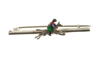 Lot 526 - Novelty bar brooch with an enamel jockey on a rose cut diamond racehorse. 52mm