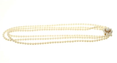 Lot 552 - Cultured freshwater pearl three strand necklace with three strings of 4.5mm cultured pearl on a 9ct gold cultured pearl and diamond cluster clasp. Approximately 41cm length.