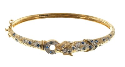 Lot 557 - Sapphire and diamond hinged bangle modelled as a leopard in 9ct gold setting.